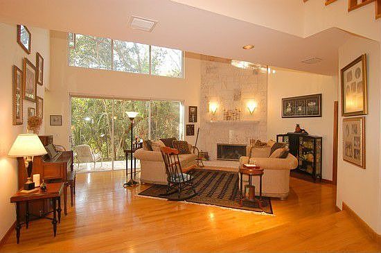 Floor to ceiling coral rock fireplace & 18 foot ceilings in Living Room