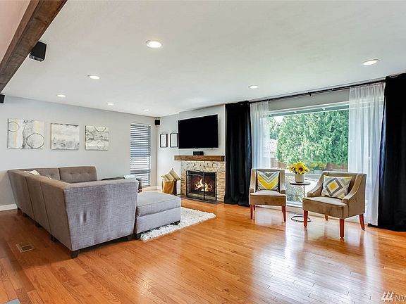 Cozy up to the wood burning fireplace and enjoy all the light coming from the huge picture window in the living room.