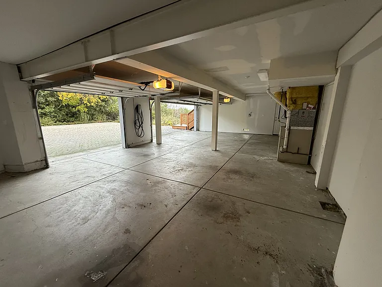 Attached three-car garage is equipped with an EV charger.