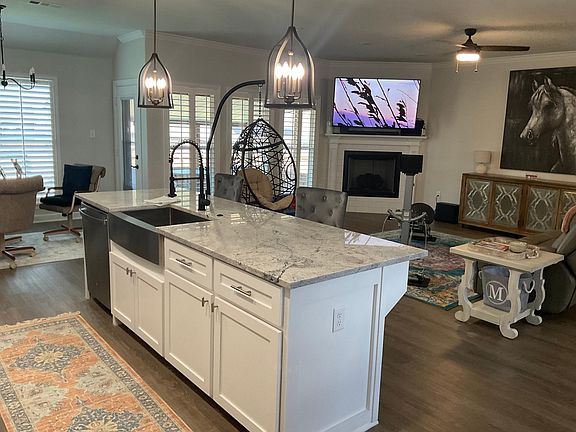 Light,bright great room with 75 inch tv over gas log fireplace
