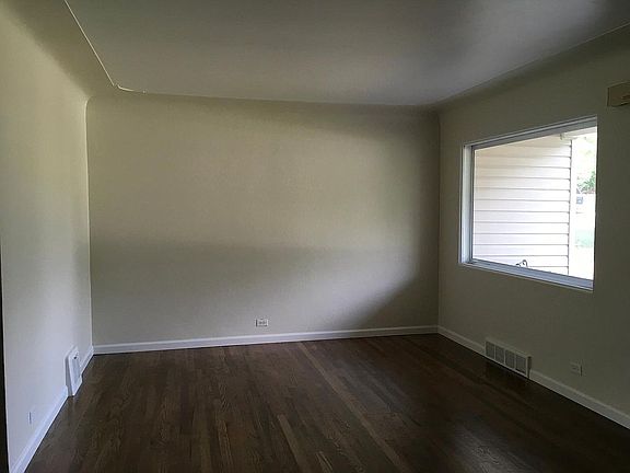 Family room with great natural light! Original hardwood floo