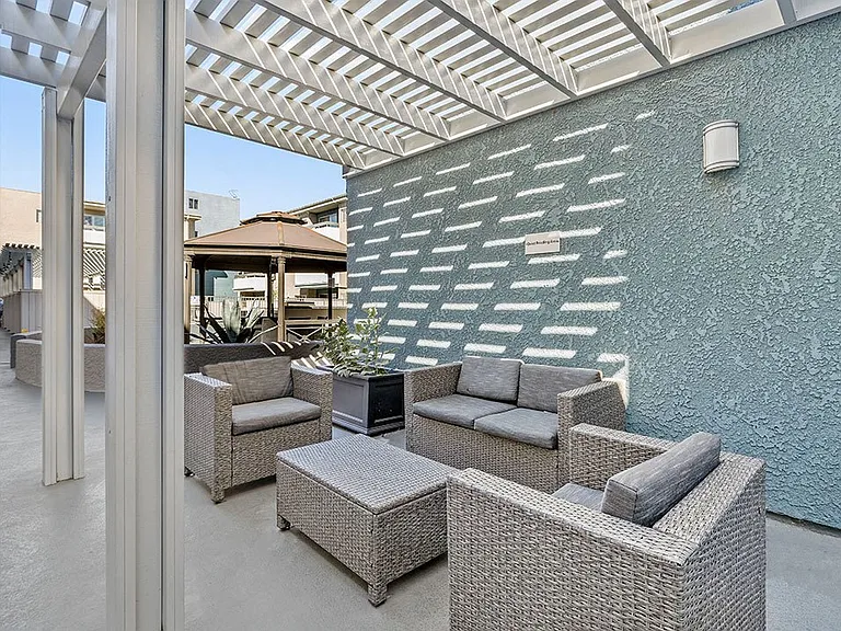 Quiet reading area outside in community courtyard with seating in shade.