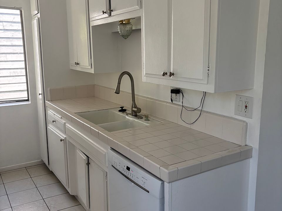 Kitchen, sink and dishwasher with lots of cabinets.