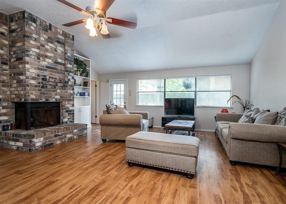 Large living space with brick fire place