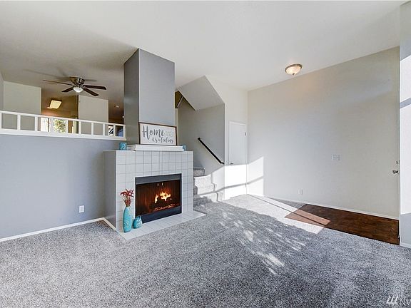 Light bright living room with high ceilings and fireplace to cozy up too!