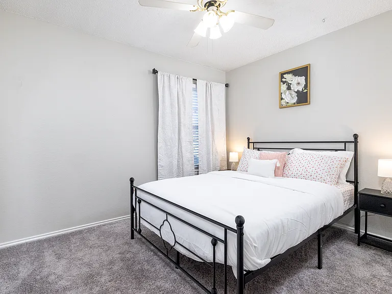 Upstairs Bedroom 2 offers a plush queen bed and cozy carpeted floors_ideal for a restful night's sleep.
