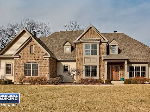 Custom Brick and Cedar beauty in coveted Lyons Ridge.