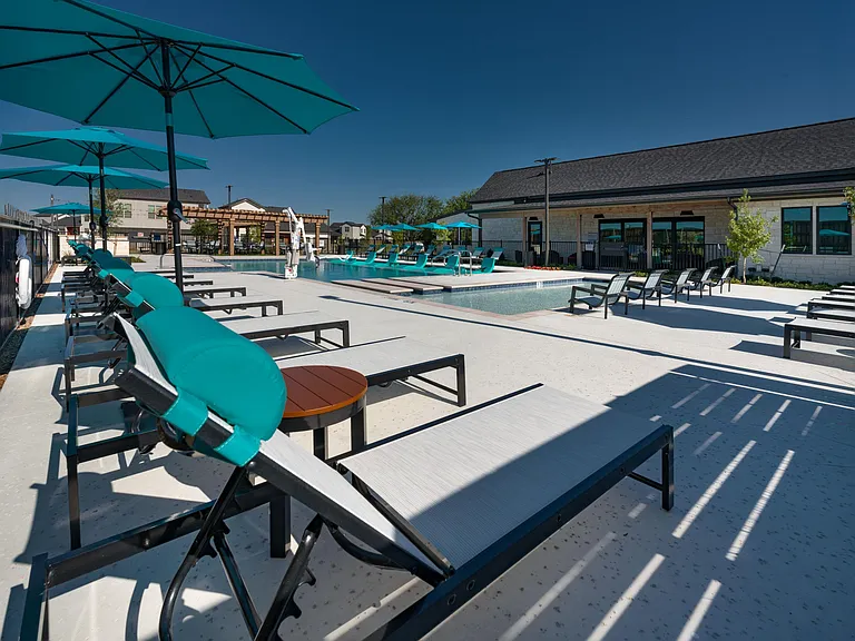 Resort-style swimming pool with lounge seating