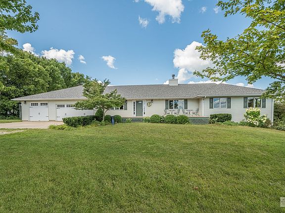 All new garage doors, including the taller third bay, and carriage lights.