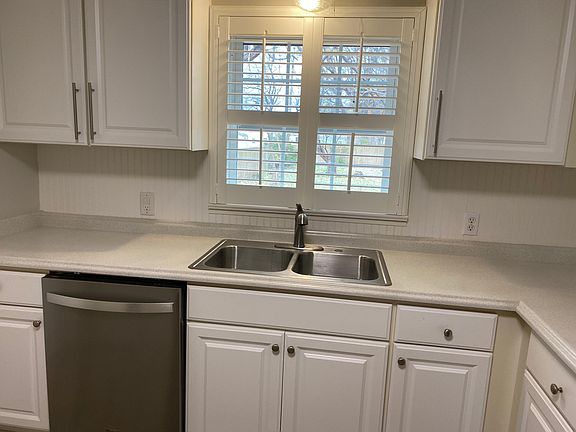 Double stainless steel sink with view of spacious backyard.
