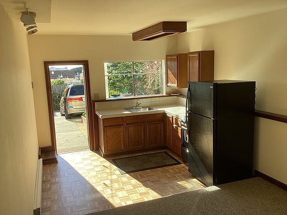 Bright, sunny kitchen overlooking yard planters.