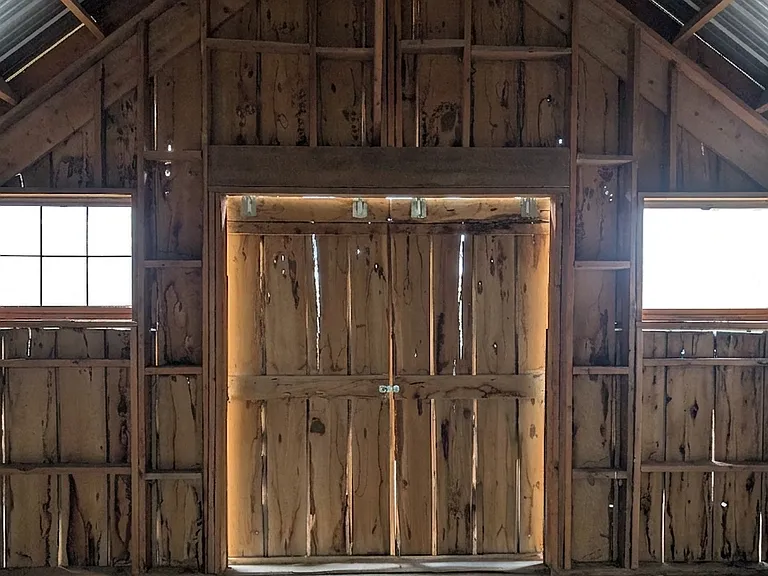 Upper level of the barn featuring rustic timber framing.