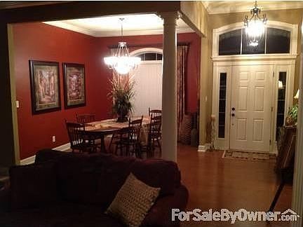 Dining Room : Tall ceiling, wood floor, skip trowel texture. Christmas tree plug at window.