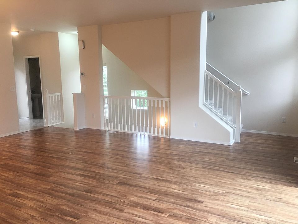Living Room with stairs leading up to bedrooms and loft
