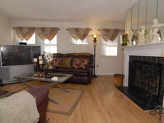 Living room w/ working wood fireplace