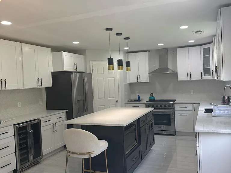 Spacious kitchen with a large island, ample shaker cabinetry, and stainless-steel appliances for easy meal prep.