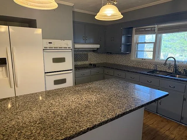 Kitchen has large fridge, double oven, electric cooktop, microwave and coffee maker with plenty of storage - Pinehurst St SW