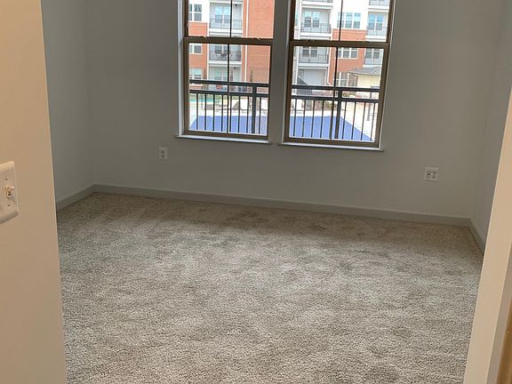 Bedroom with windows overlooking pool and garden area