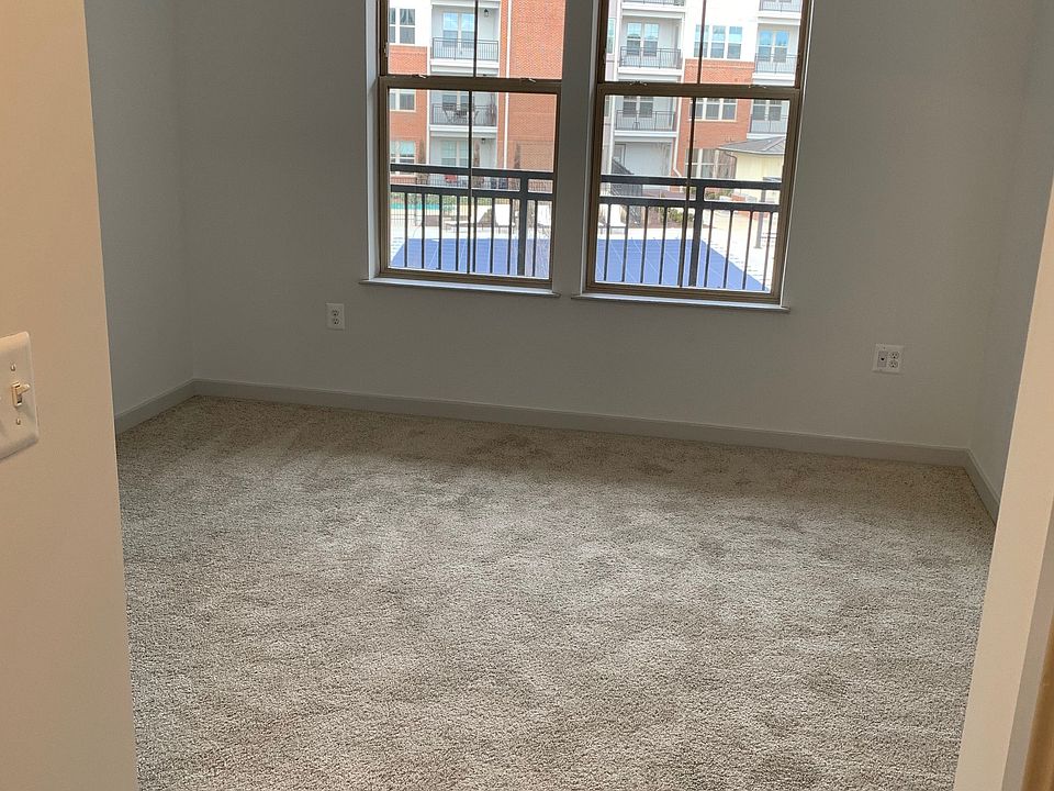 Bedroom with windows overlooking pool and garden area