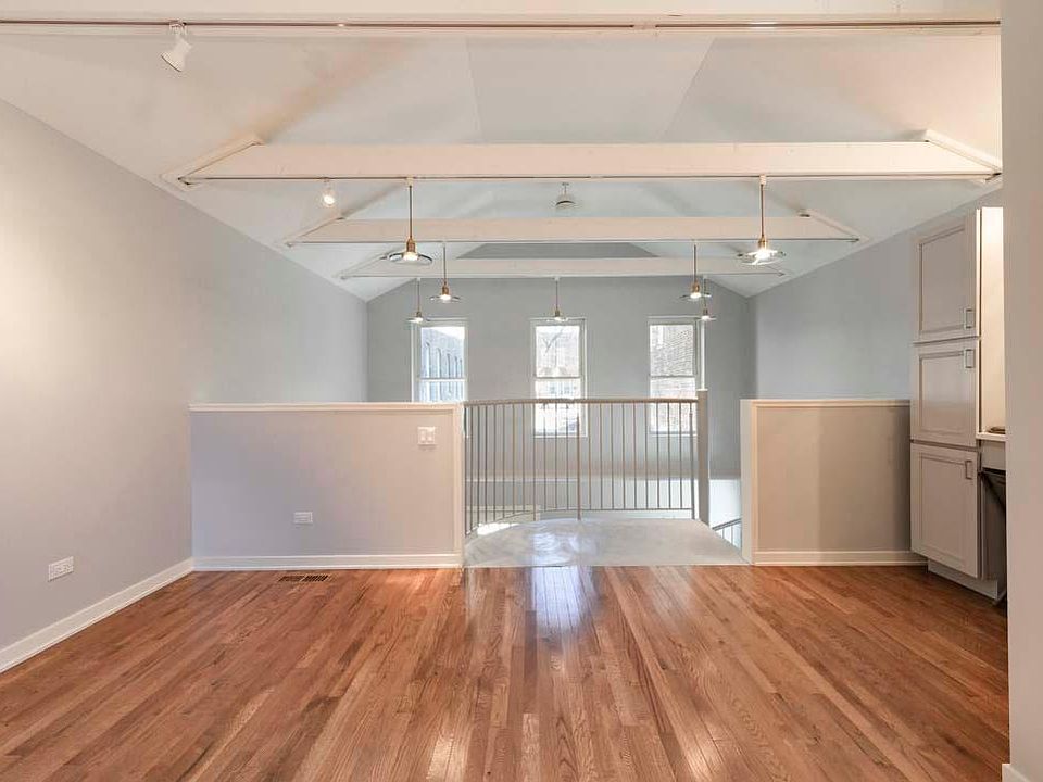 Bedroom area with spiral stair and overlook. Windows facing east overlooking shared terrace.