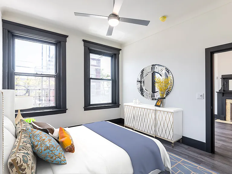 Bedroom offers large windows, barn door over closet and cool fan.