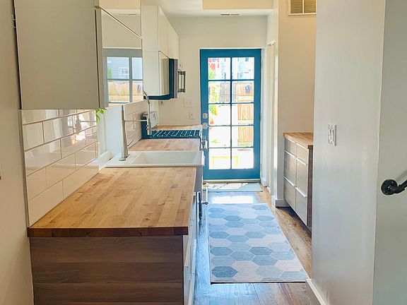 Updated kitchen with stainless steel appliances and farmhouse sink