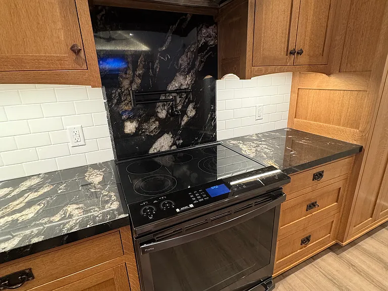 GE Profile Electric Range flanked by granite counters