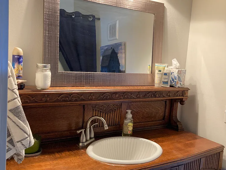 Hall bathroom with antique furniture washstand.