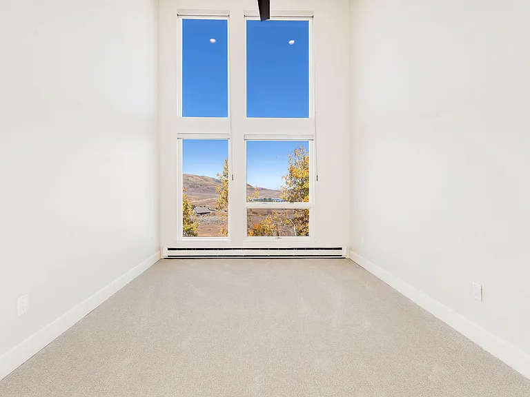 Bedroom #2 - on upper level. Floor to ceiling windows with electric black out window shades.