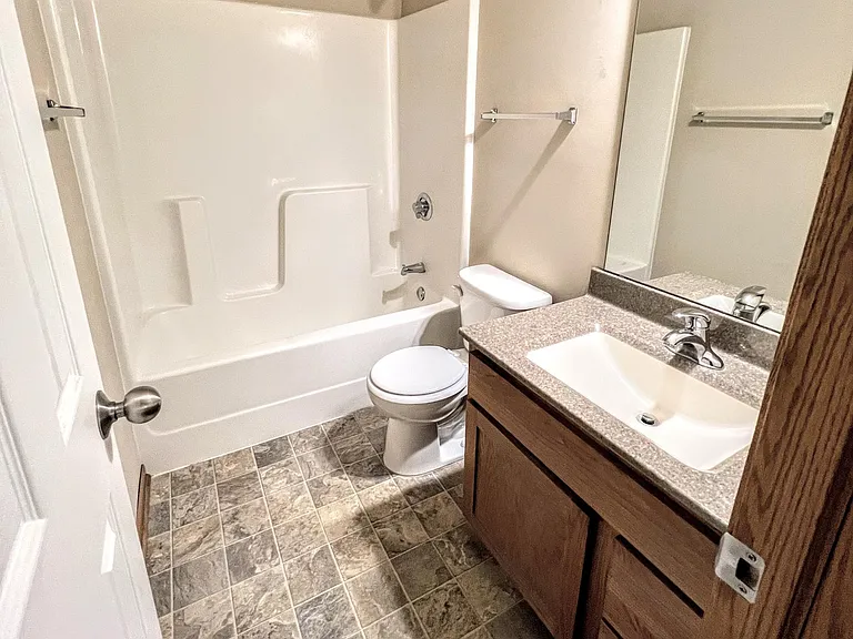 Upstairs main bath. It now has LVT flooring.