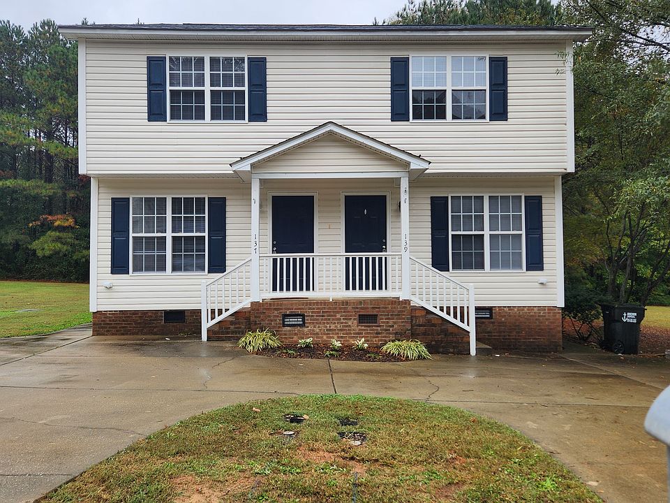 Exterior Front, large concrete driveway