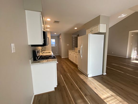 Kitchen with refrigerator, dishwasher and stove