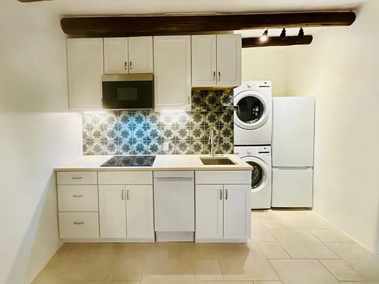 Living room, kitchen area. New in unit washer & dryer as well as fridge/freezer. Induction stove and microwave.