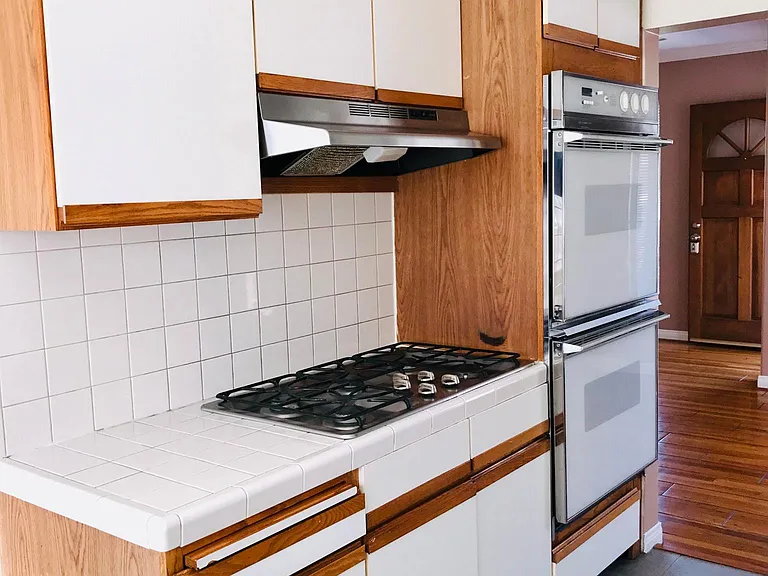 Newer stainless steel style range and exhaust hood. Double Oven!