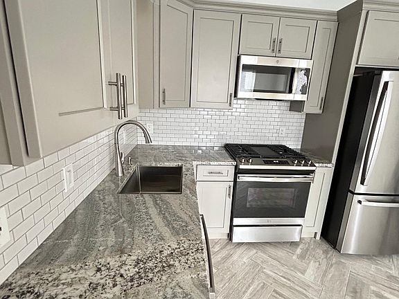 Granite countertops, extra deep sink, slide in gas range.