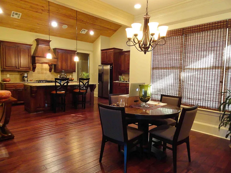 Dining room and kitchen. Dining room has space for a much larger rectangular table, and also looks complete with small and medium size tables.