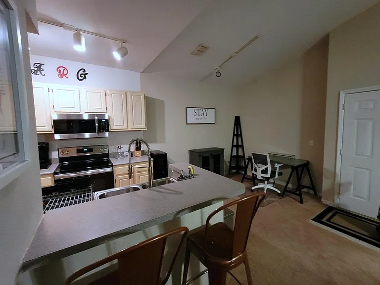L-shaped bar counter with stools.