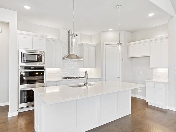 Kitchen in the Denali home plan by Trophy Signature Homes - REPRESENTATIVE PHOTO