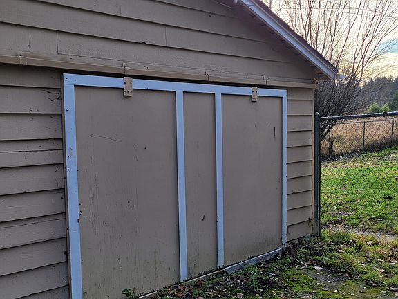 Garage is large and could fit 2 cars if needed although opening meant for one. Automatic garage door opener slides door to the left when opening.