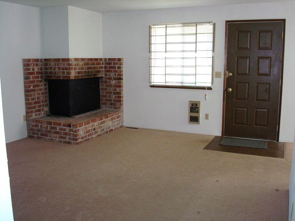 Living room (view of wood fireplace and front door)