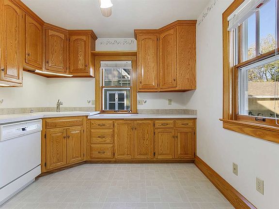 Over sized cabinets flank the walls of the sparkling sun drenched kitchen