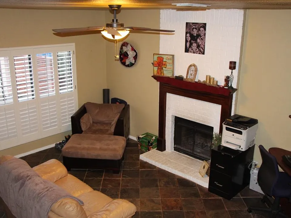 Living Room Boasts Fireplace, Slate Floors, Plantation Shutt