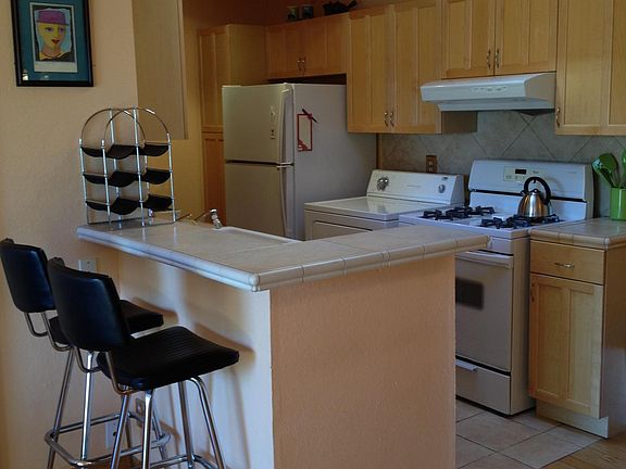 Kitchen with counter, stools, appliances
