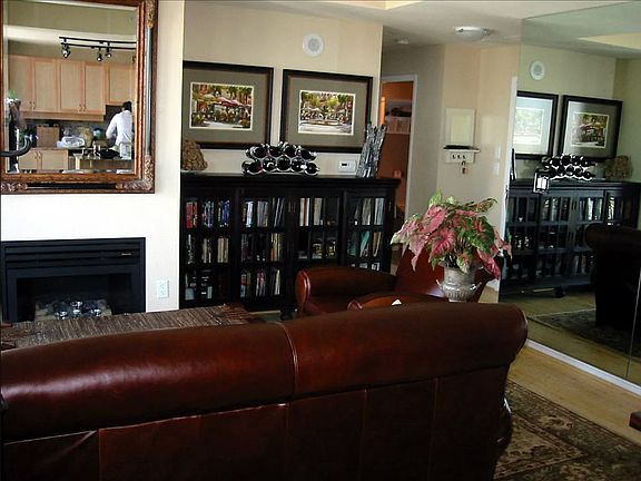 Living room from dining area towards front door.