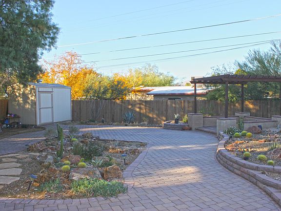Custom brick paver back yard with Storage shed and Pergola