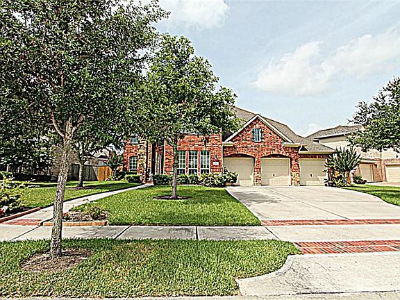 THE ARTISTICALLY DESIGNED LANDSCAPING WELCOMES YOU HOME HAS YOU APPROACH THE COVERED FRONT PORCH