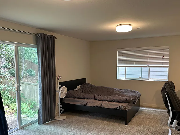 First Floor - Bedroom, with 0.75-bath, and walk-in closet. Facing backyard.