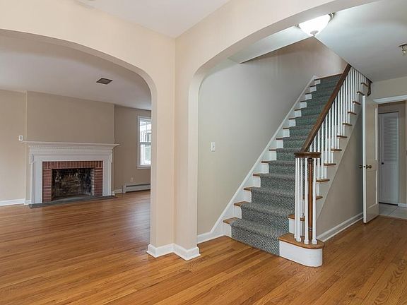 Foyer. Open to living room with fireplace, dining room and hallway