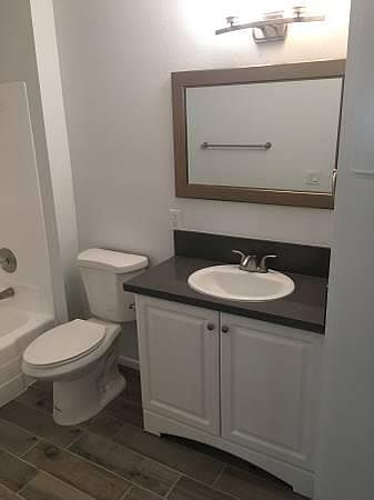 Fully remodeled bathroom. Quartz countertop matches the kitc
