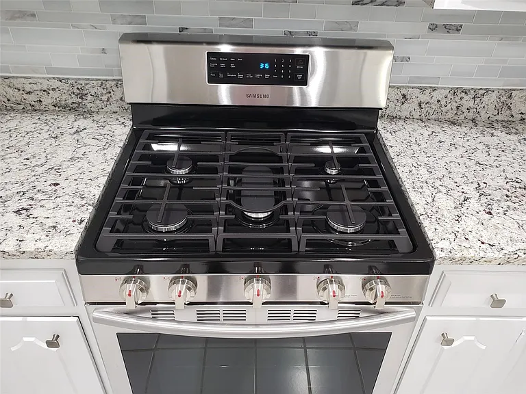 Gas stovetop with a convection oven.